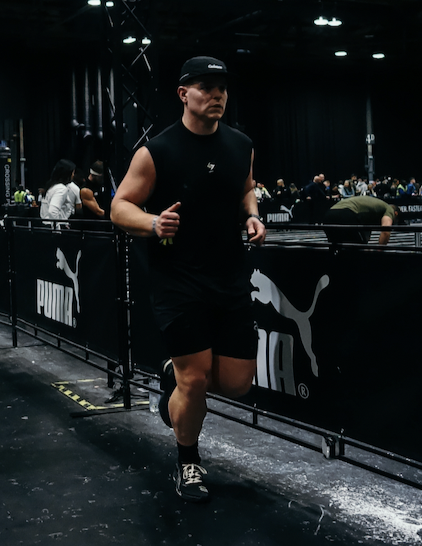 Athlete running at an indoor fitness event